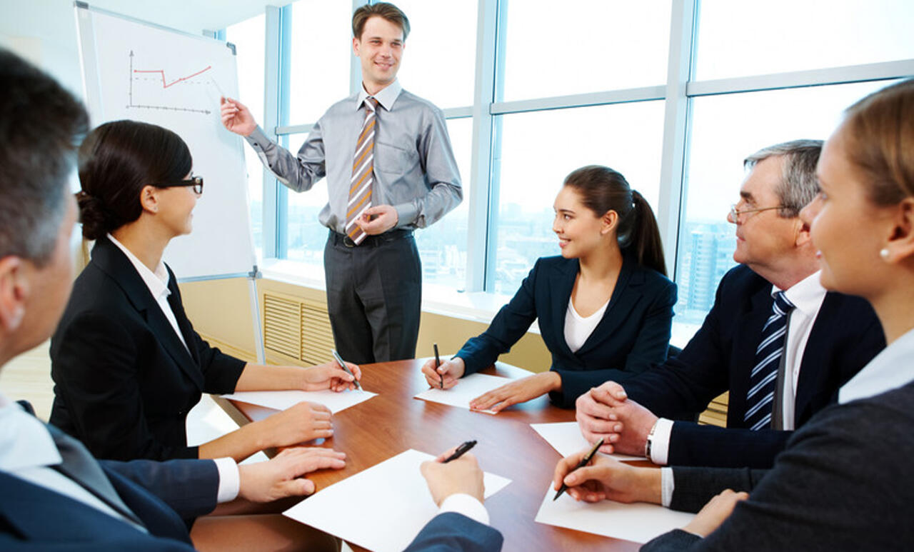 Business leader addressing a boardroom, illustrating NKABC Confidante’s advisory for founders, CEOs, and investors.