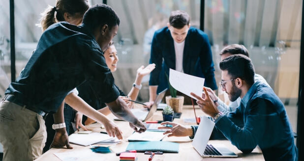 Business leaders in a meeting planning organizational strategy and staff training under advisory from NKABC Confidante.